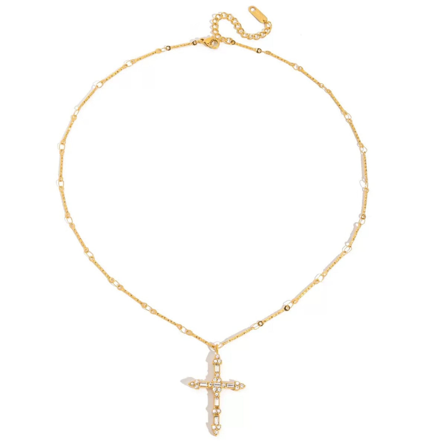 A delicate gold chain necklace featuring a cross pendant adorned with small clear crystals, displayed on a clean white background.