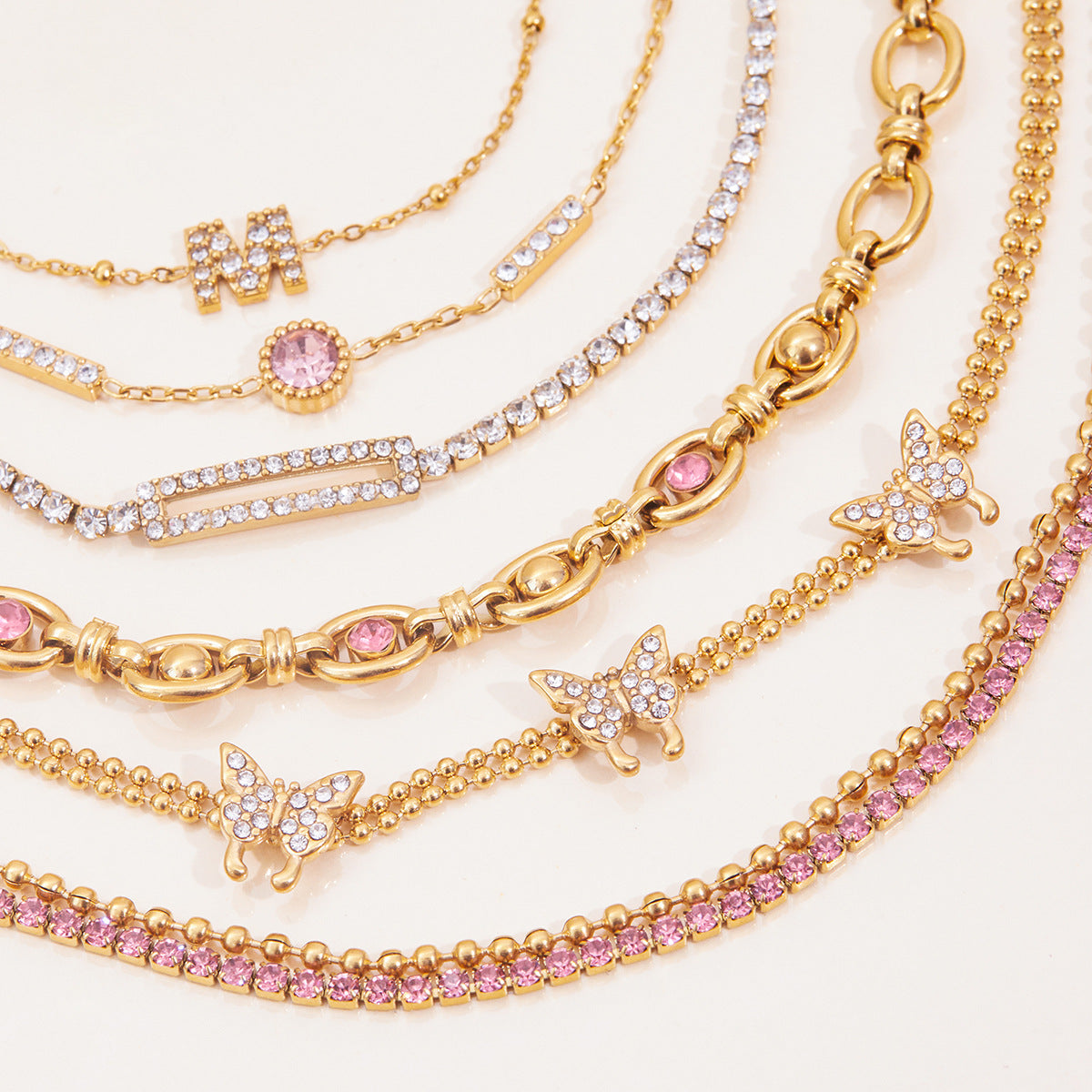 Gold Layered Bracelet Set with Butterfly, Pink Gemstones & Crown Charm