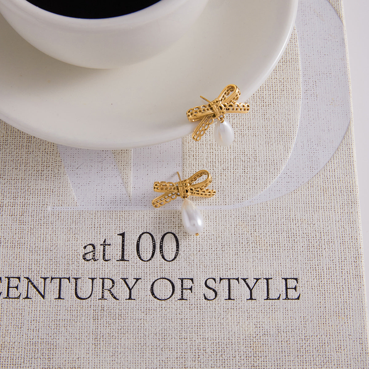 Golden Bow - Shaped Earrings with Teardrop - shaped Pearl