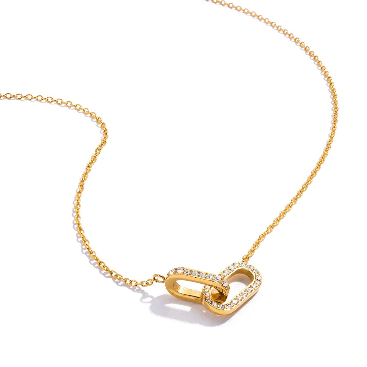 Gold necklace with a unique clasp design on a white background