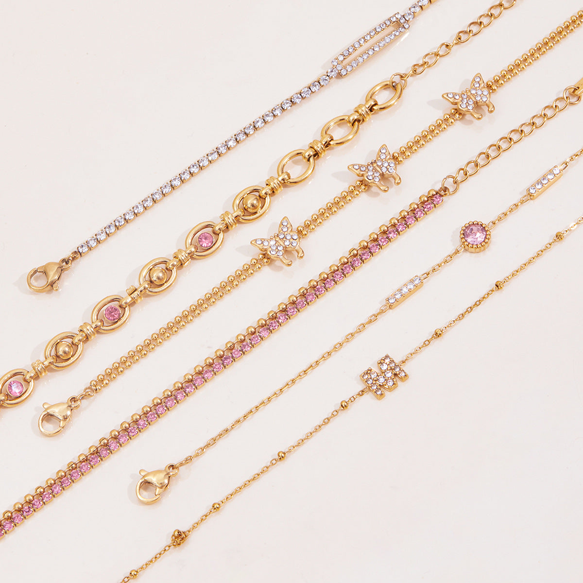 Gold Layered Bracelet Set with Butterfly, Pink Gemstones & Crown Charm