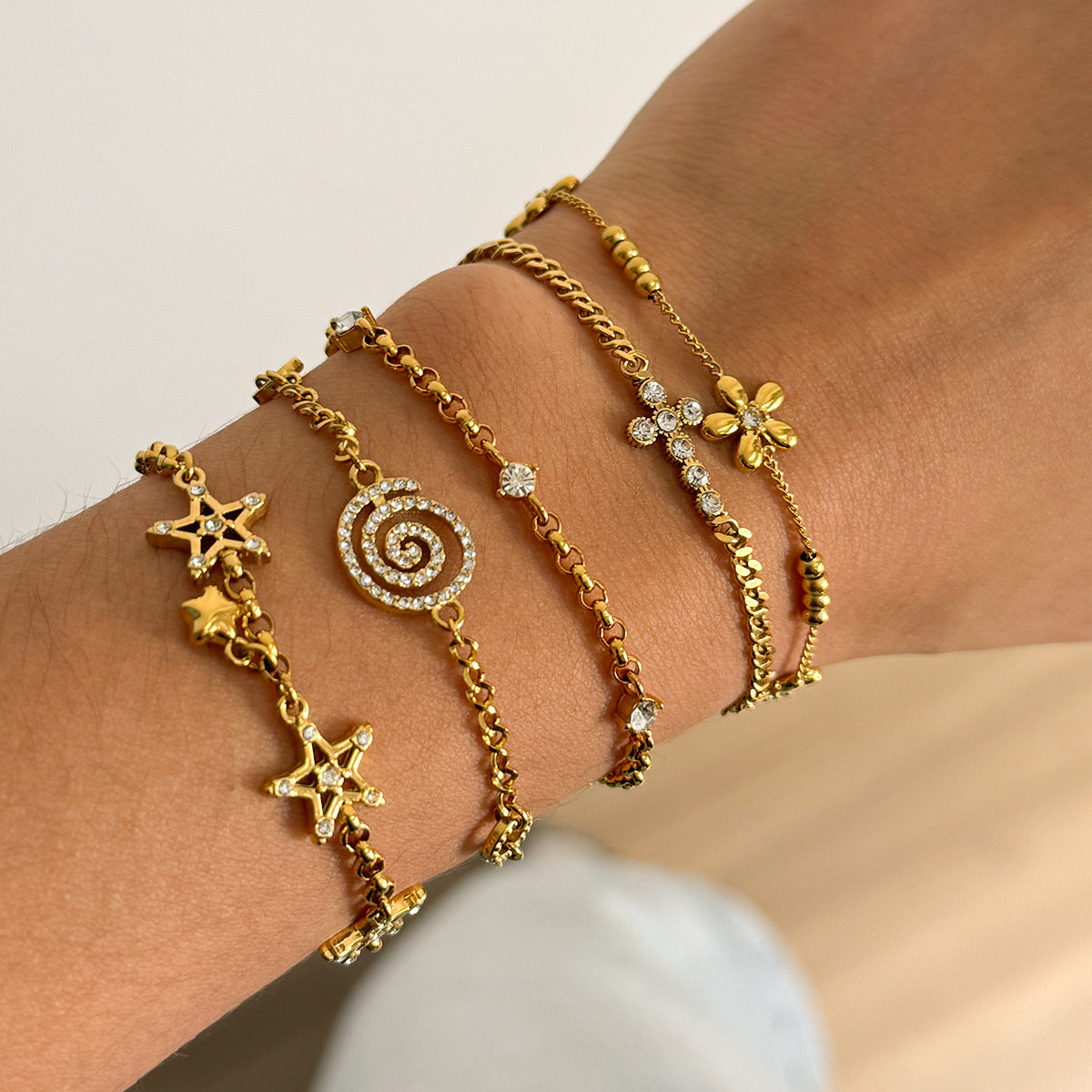 Layered Bracelet Set with Stars, Spiral Pendant, Cross Charms & Flower Charm