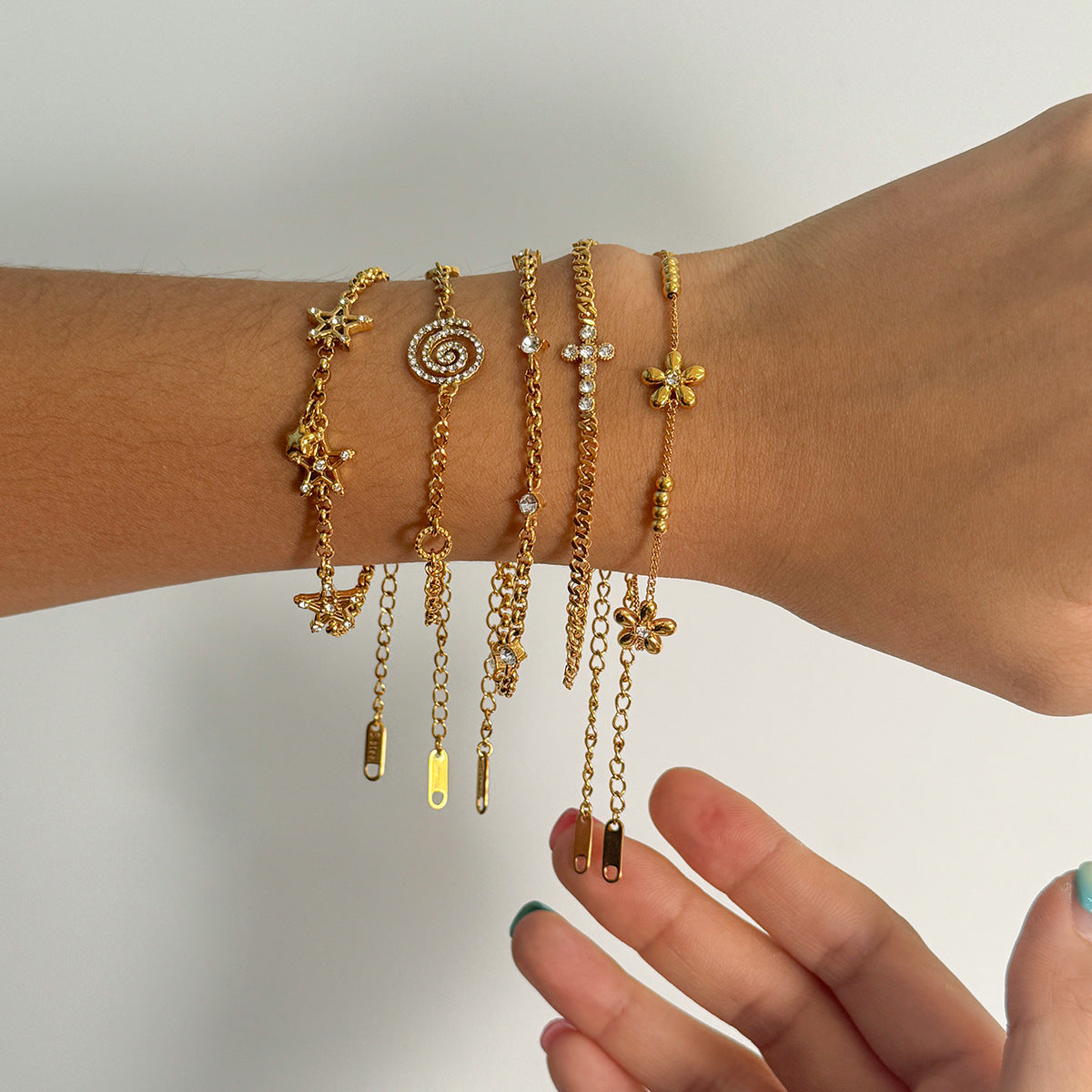 Layered Bracelet Set with Stars, Spiral Pendant, Cross Charms & Flower Charm