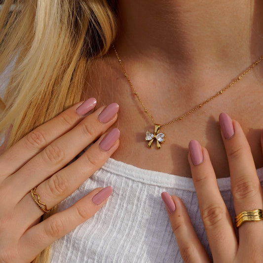 Gold - Plated Bow - Shaped Pendant Necklace with Heart - Cut Crystals