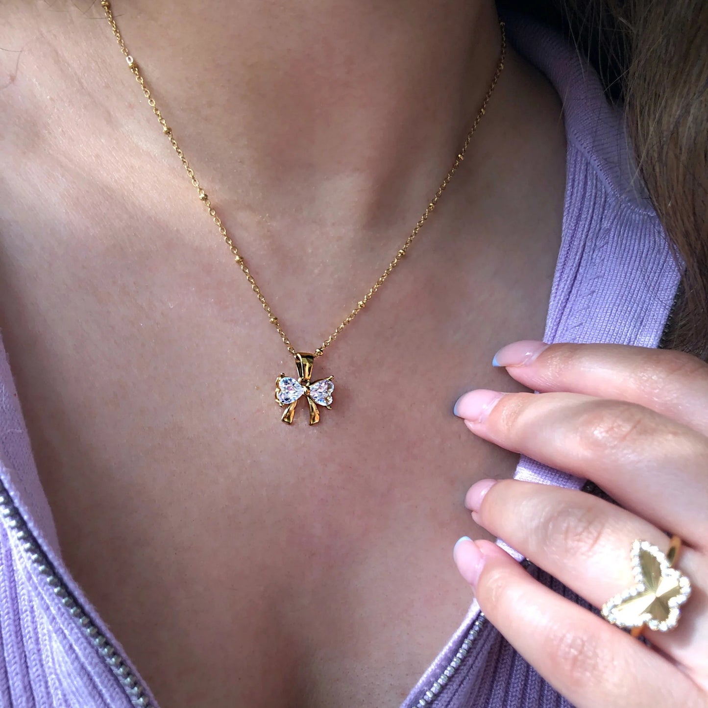Gold - Plated Bow - Shaped Pendant Necklace with Heart - Cut Crystals