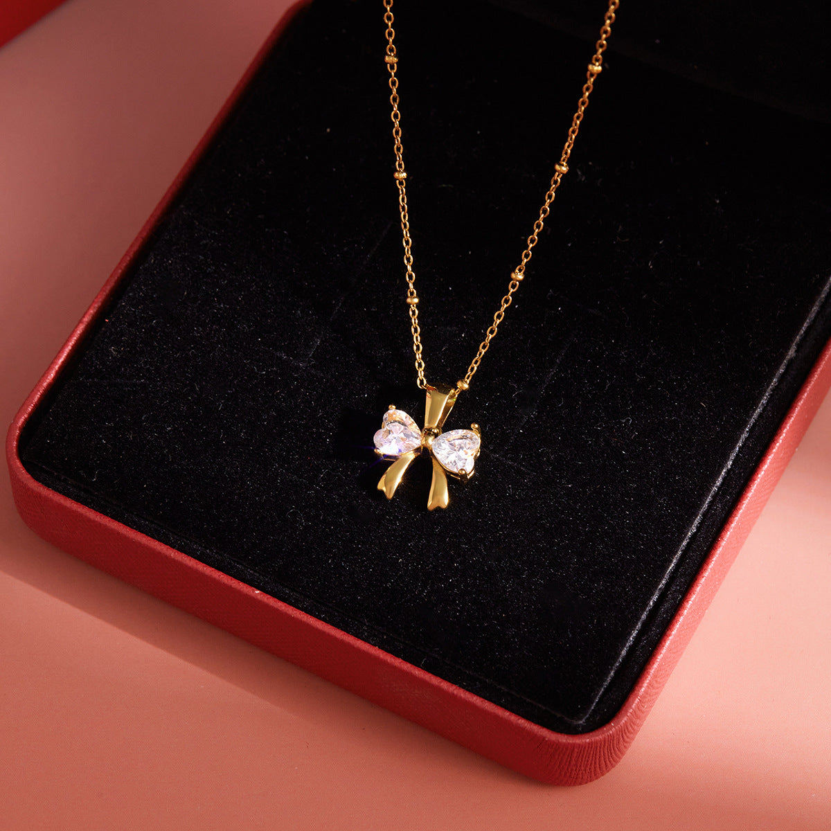 Gold - Plated Bow - Shaped Pendant Necklace with Heart - Cut Crystals