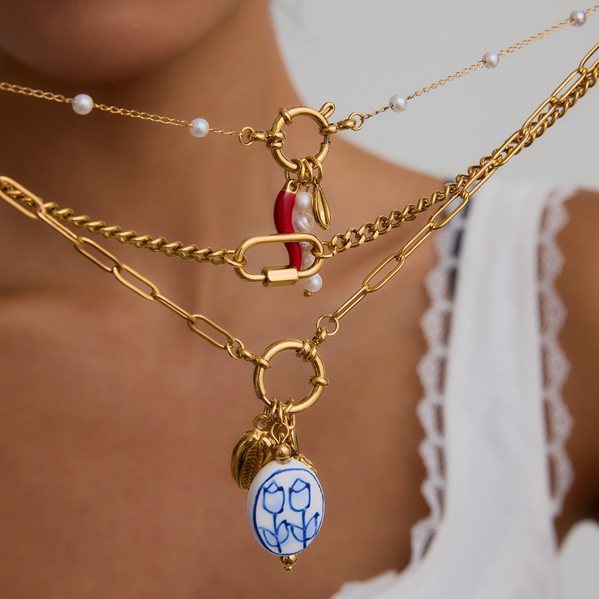 Multi - Layered Gold Necklace with Pearl and Charm Details