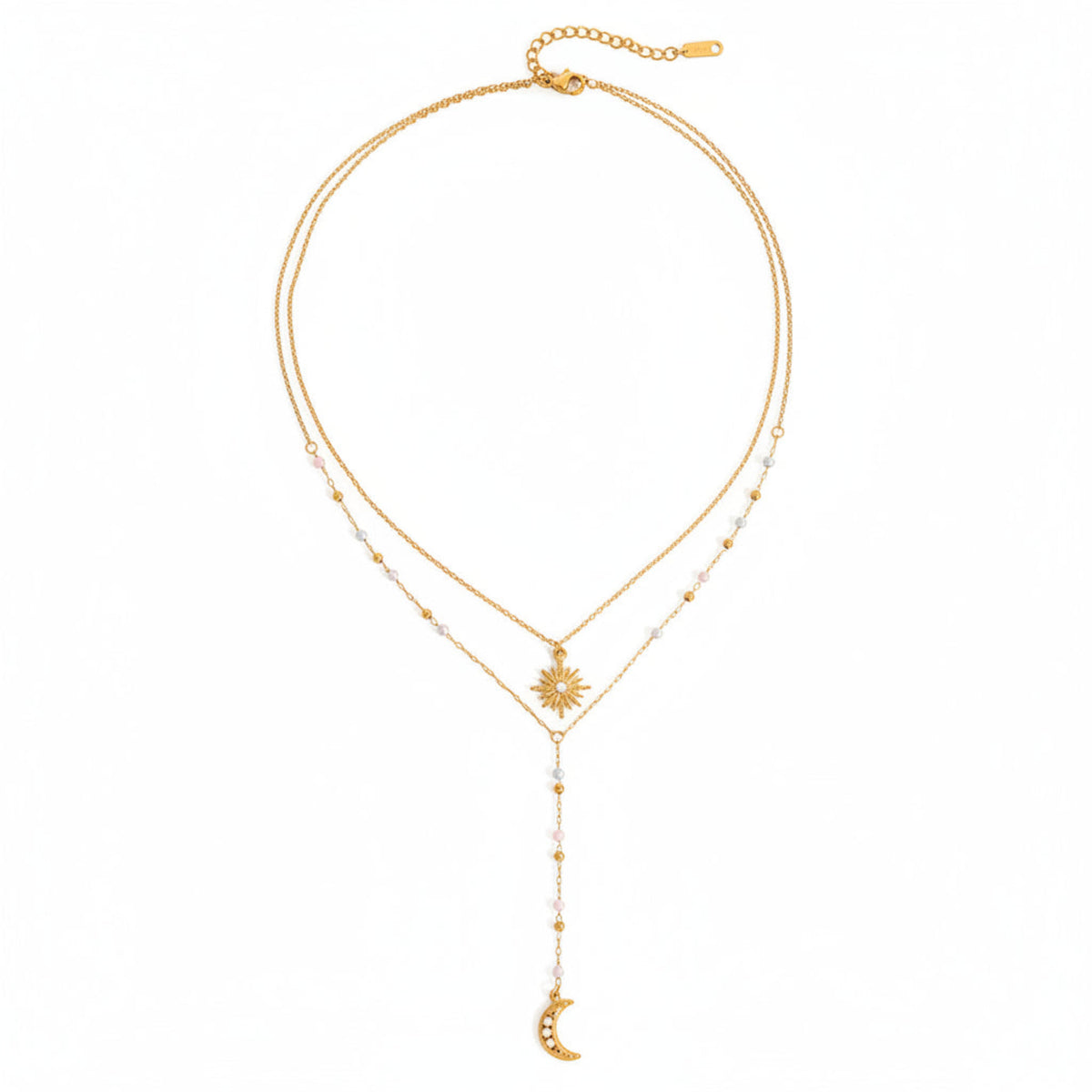 Gold necklace with star and moon pendants on a white background