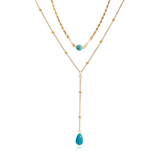 Two gold necklaces with turquoise beads on a white background